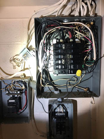 This picture shows a sub panel installation in Parker, CO. It shows two subpanels right next to the main electrical panel.